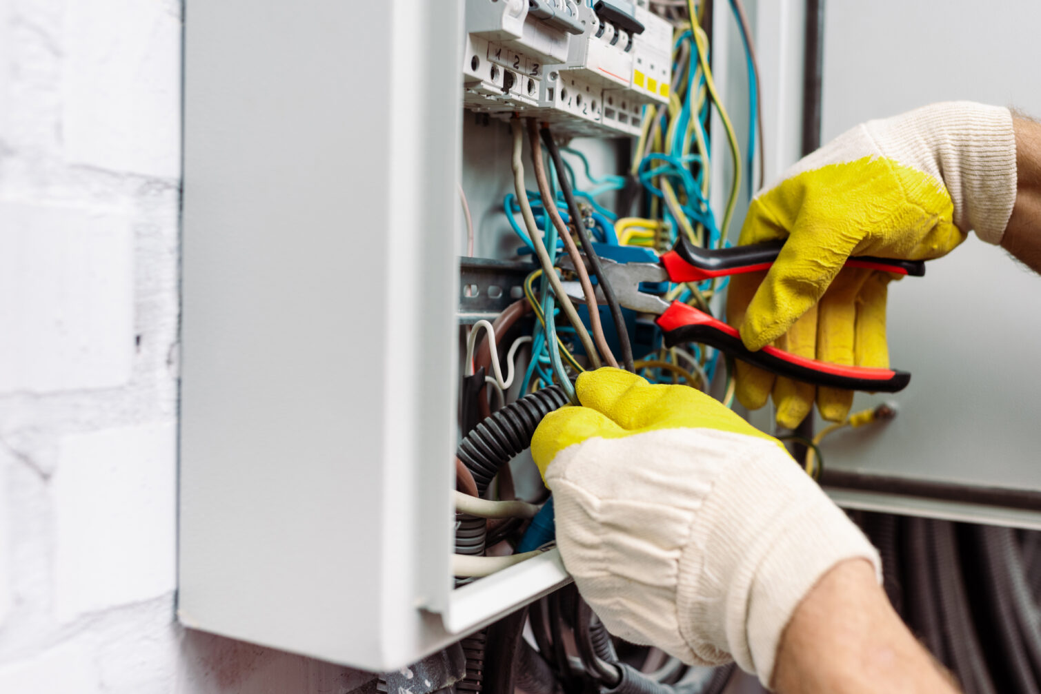Electrician repairing electrical board Services Luminous llc