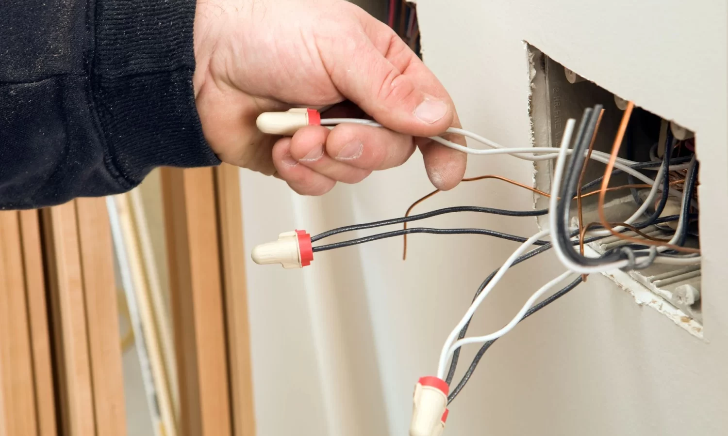 professional electrician working on a circuit board