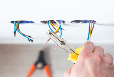 Male hands repair the socket